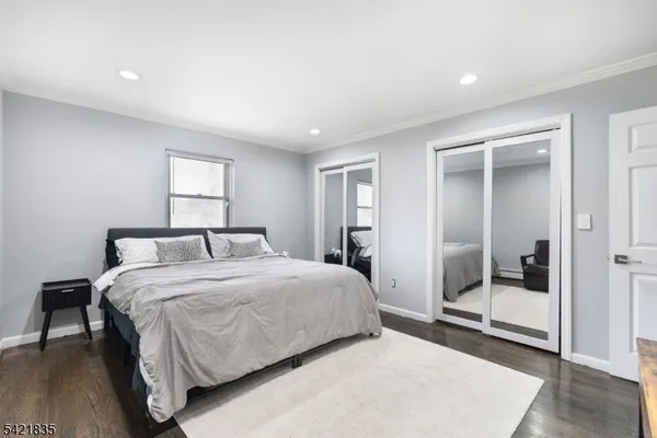 a bedroom with a bed and a mirror