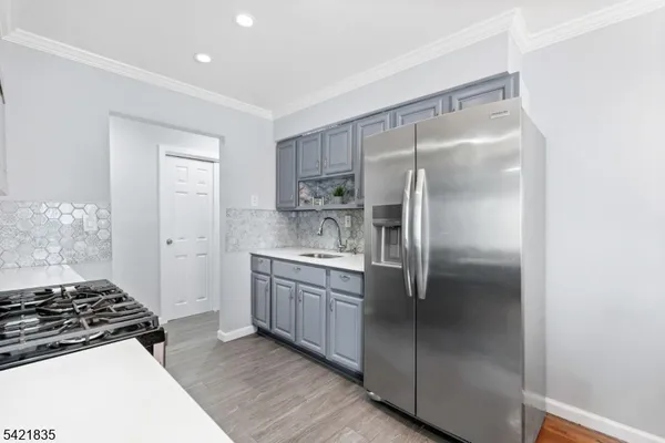 a kitchen with a refrigerator and a sink