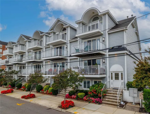 a front view of a residential apartment building with a yard