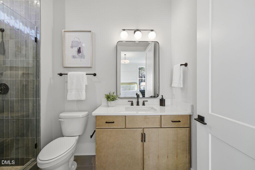8729 Allison Road Cedar Grove, NC 27231 - Photo 16 of 63 a bathroom with a sink a toilet and shower