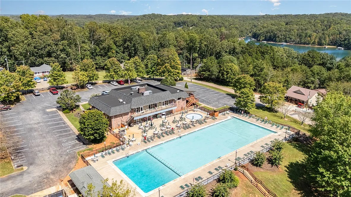355 Beech Drive Westminster, SC 29693 - Photo 9 of 9 An aerial perspective reveals a vibrant community hub with a large swimming pool, ample parking, and lakeside views.