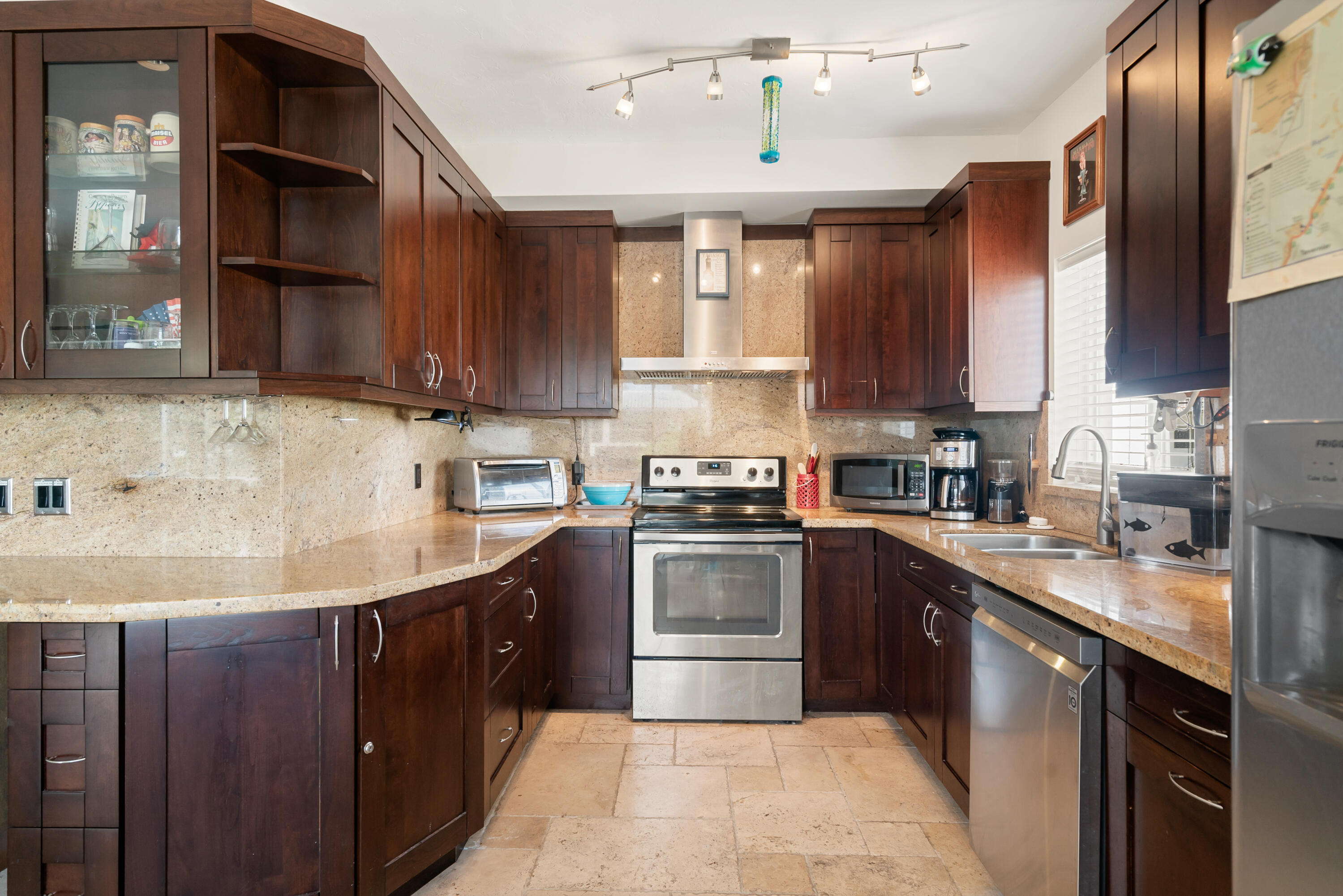 311 Buttonwood Circle Key Largo, FL 33037 - Photo 17 of 38 a kitchen with stainless steel appliances granite countertop a sink a stove top oven a counter space and cabinets