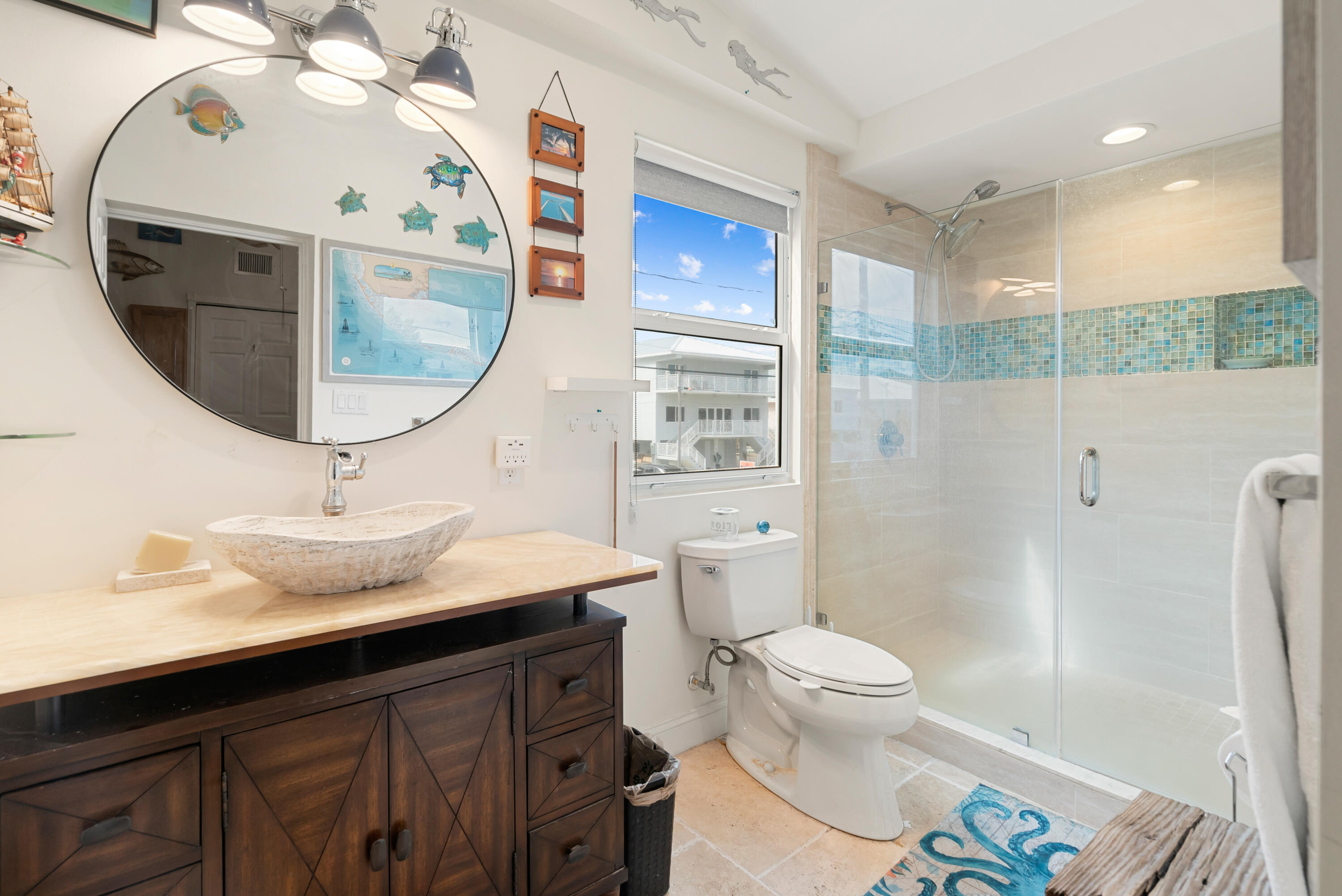 311 Buttonwood Circle Key Largo, FL 33037 - Photo 22 of 38 a bathroom with a sink a toilet and a mirror