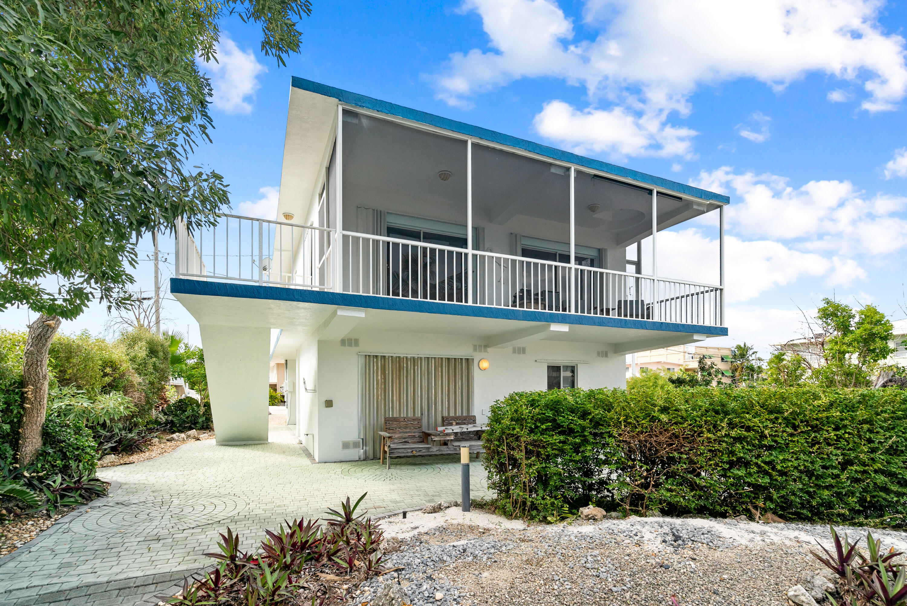 311 Buttonwood Circle Key Largo, FL 33037 - Photo 25 of 38 a view of a house with a yard and potted plants