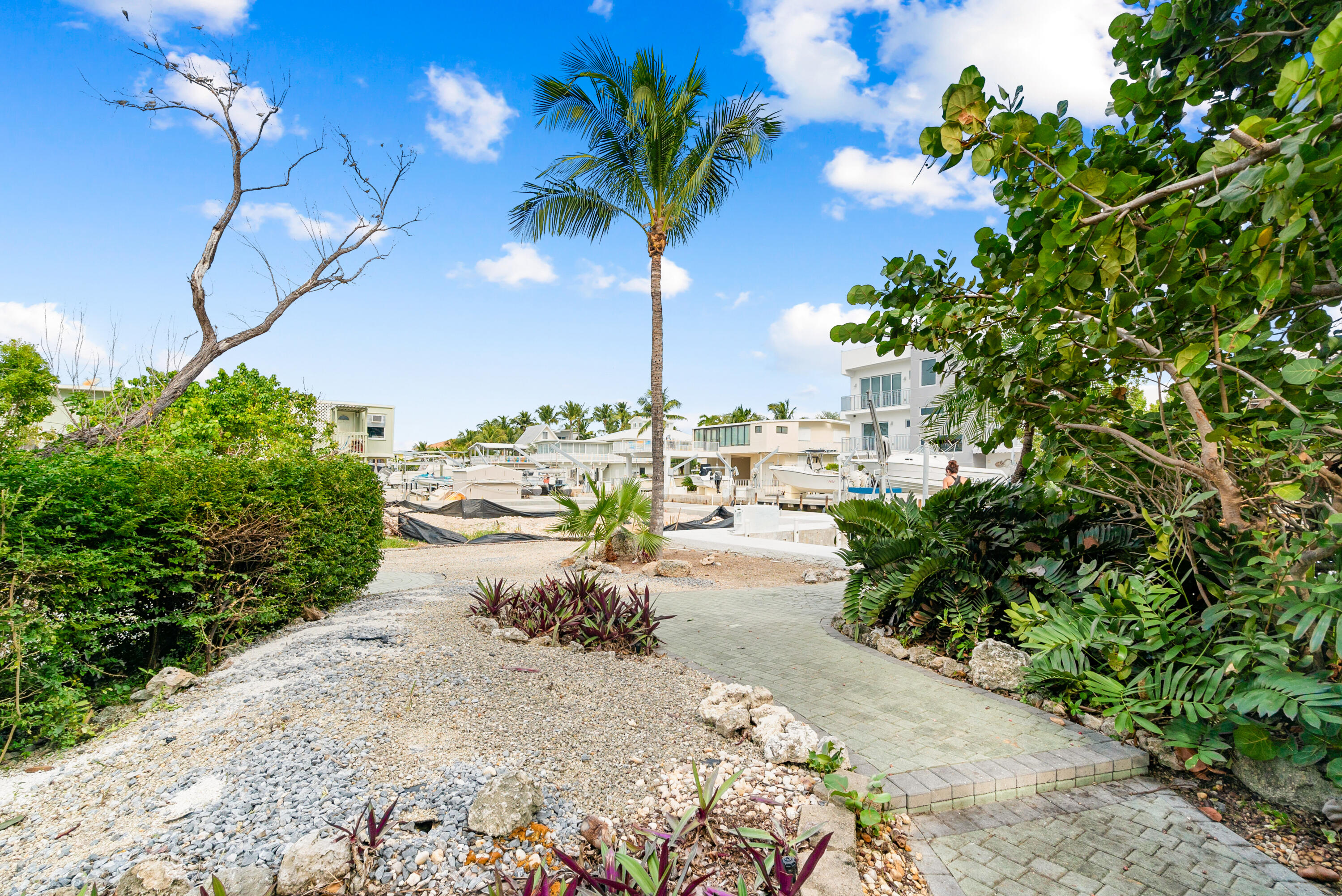 311 Buttonwood Circle Key Largo, FL 33037 - Photo 28 of 38 a view of a terrace with a garden