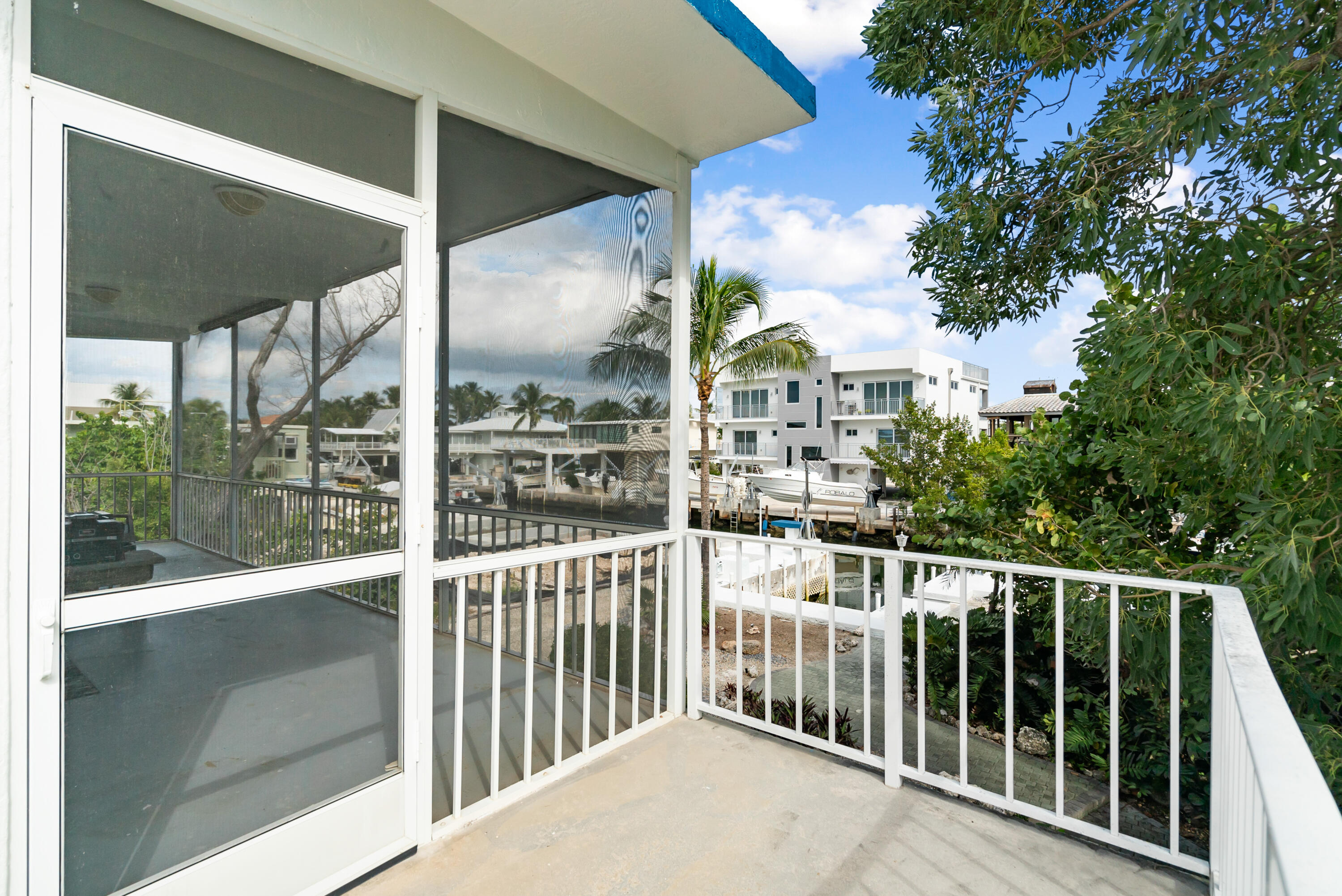 311 Buttonwood Circle Key Largo, FL 33037 - Photo 38 of 38 a view of a balcony with a floor to ceiling window and wooden fence