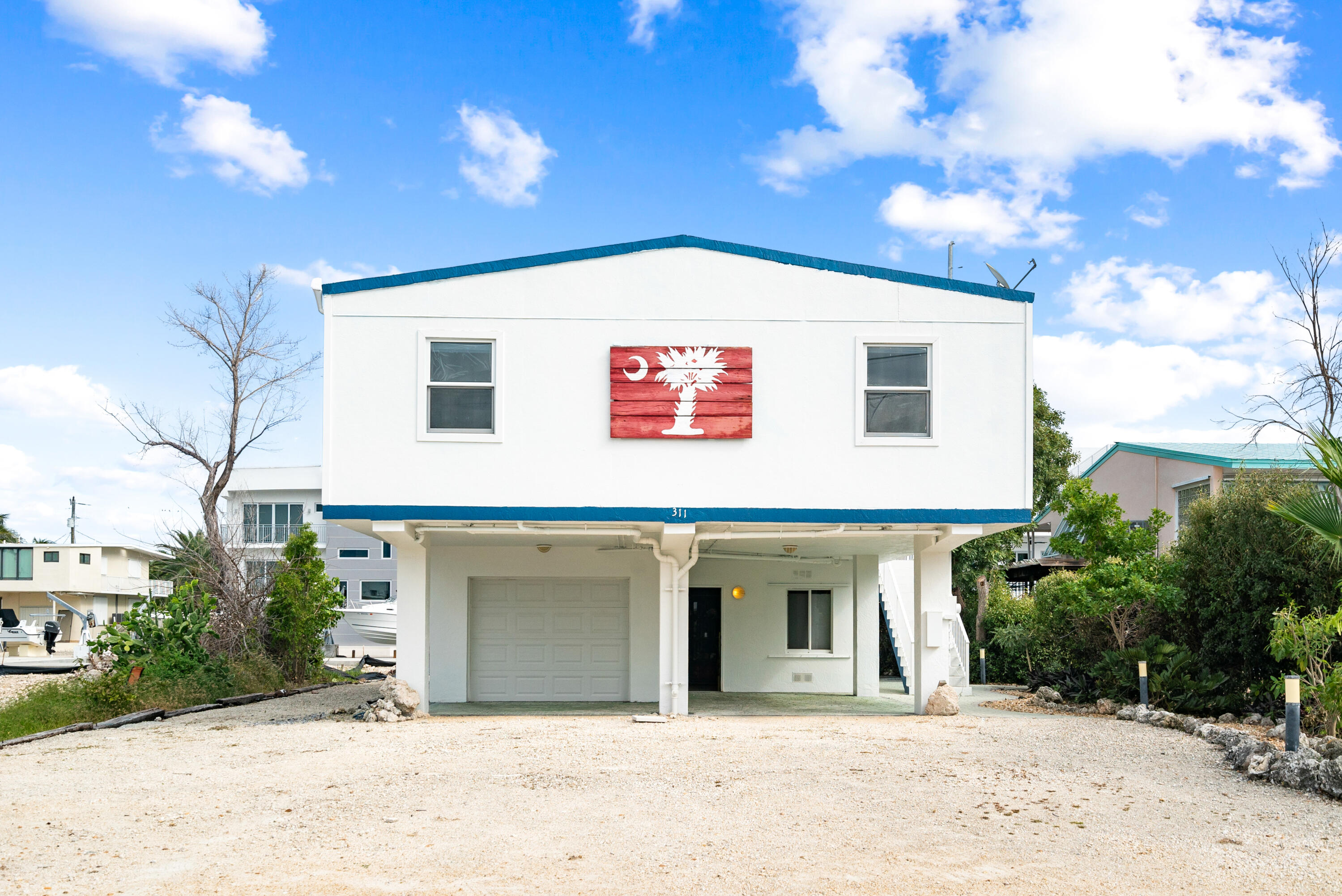 311 Buttonwood Circle Key Largo, FL 33037 - Photo 38 of 38 a view of a white house with a outdoor space