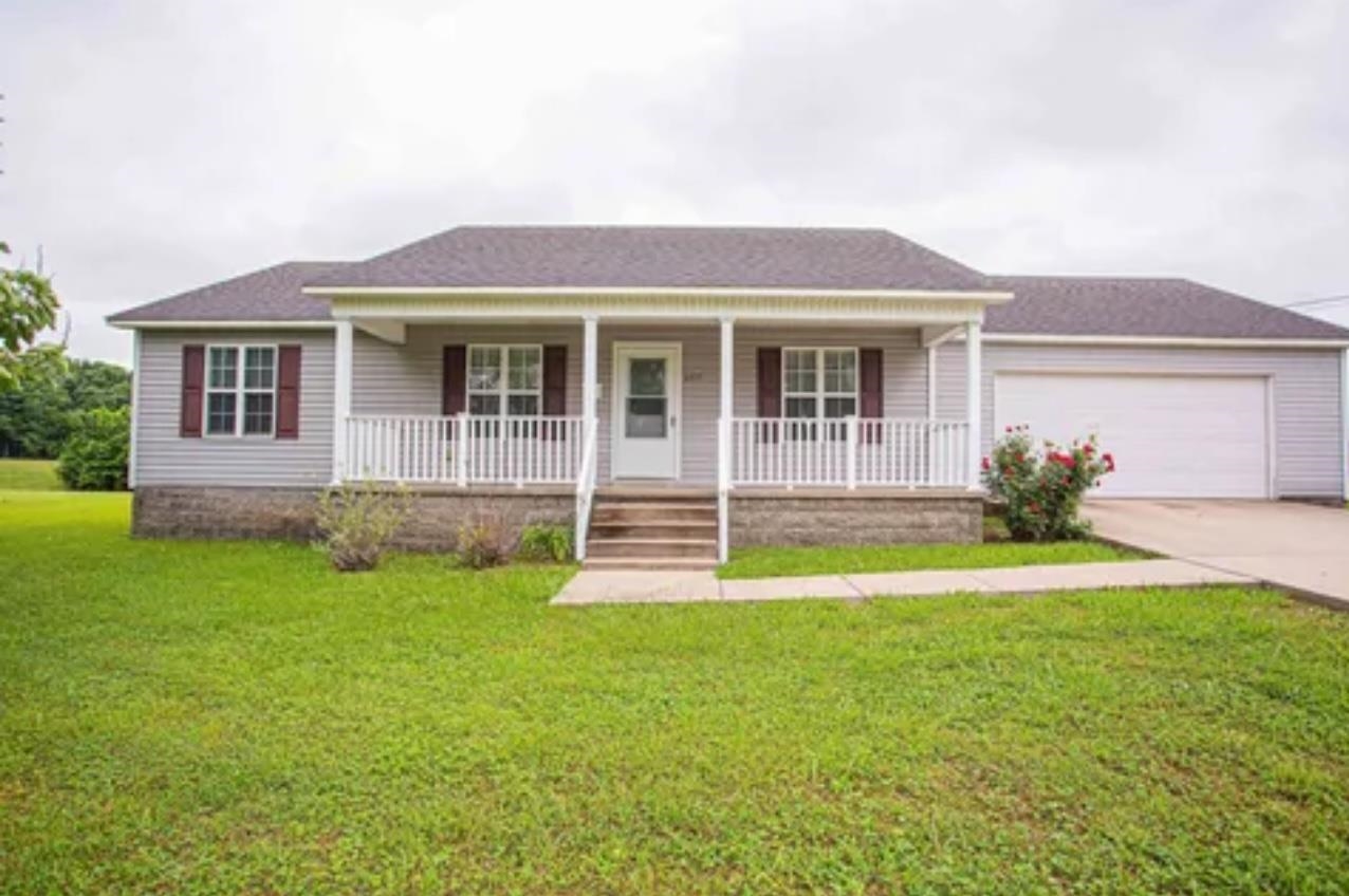 605 Salem Church Road Henning, TN 38041 - Photo 1 of 1 Ranch-style home featuring a porch, a garage, and a front lawn