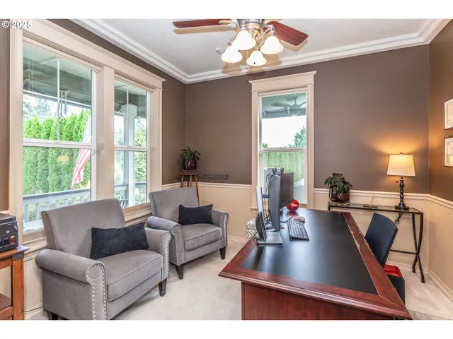 a living room with furniture a flat screen tv and a large window