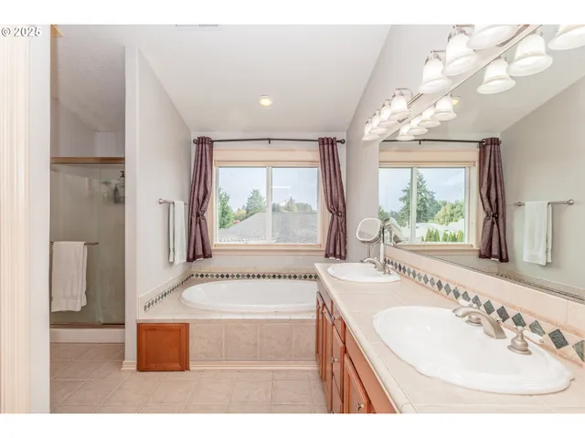 a bathroom with a tub sink and mirror