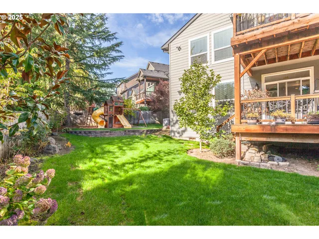 a view of a house with a yard and sitting area