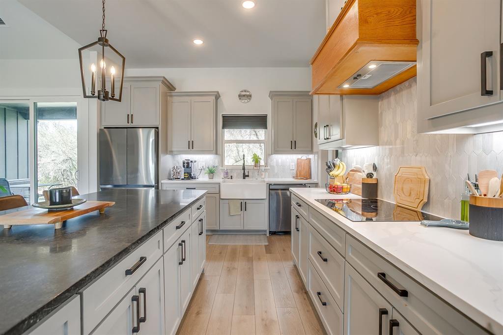 1040 Rose Court Nemo, TX 76070 - Photo 12 of 40 a kitchen with stainless steel appliances granite countertop a sink a stove and a refrigerator