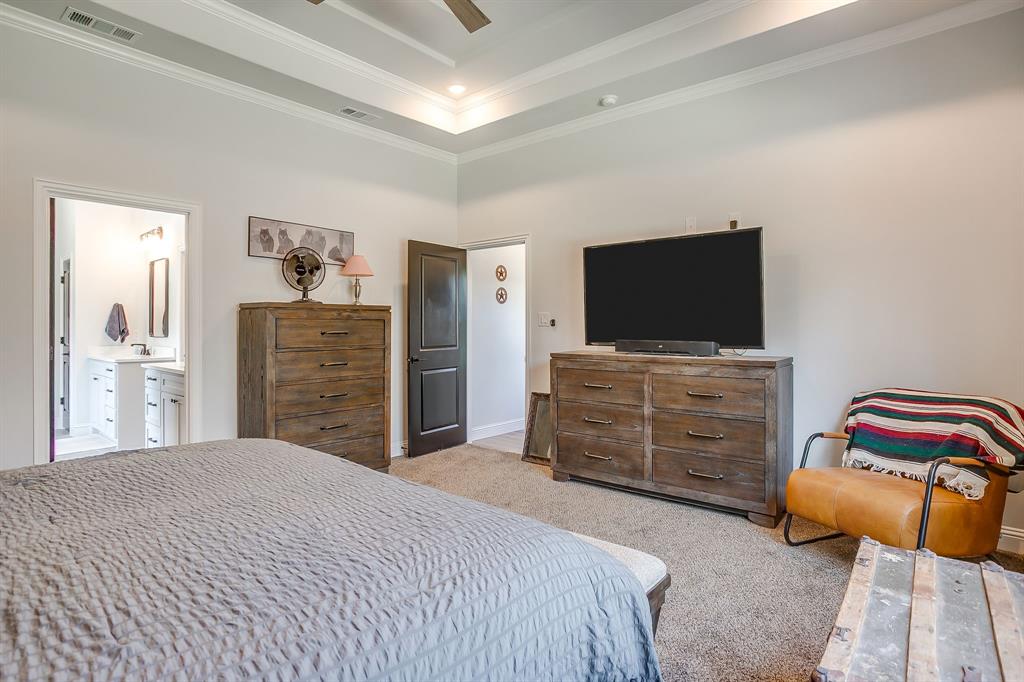 1040 Rose Court Nemo, TX 76070 - Photo 22 of 40 a bedroom with a dresser and flat screen tv