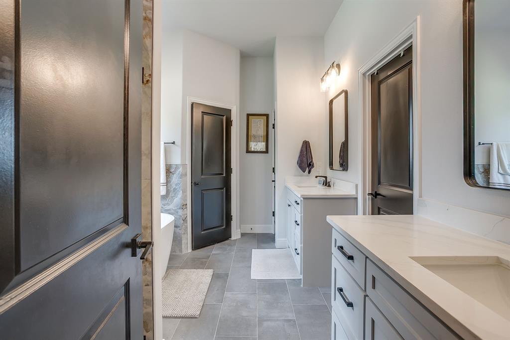 1040 Rose Court Nemo, TX 76070 - Photo 27 of 40 a bathroom with a double vanity sink mirror and shower