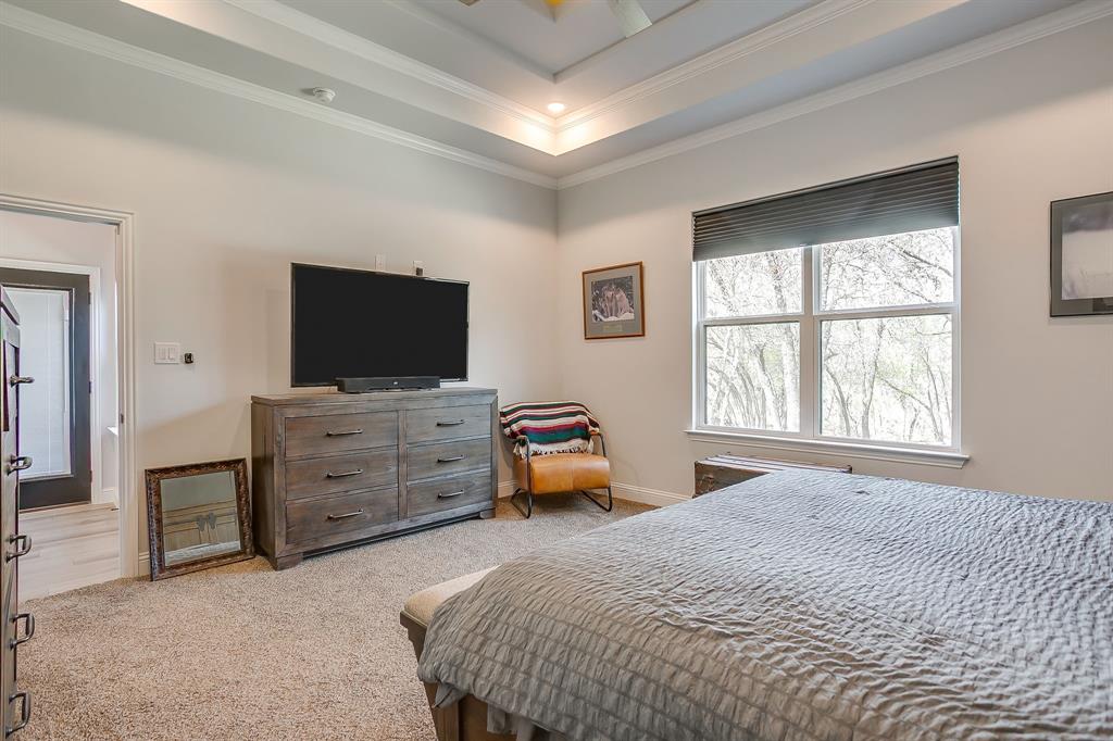 1040 Rose Court Nemo, TX 76070 - Photo 28 of 40 a bedroom with a bed and flat screen tv