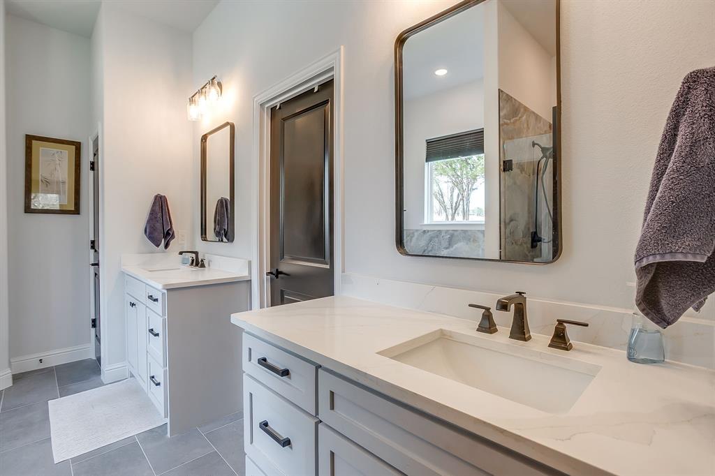 1040 Rose Court Nemo, TX 76070 - Photo 29 of 40 a bathroom with double vanity sink and mirror