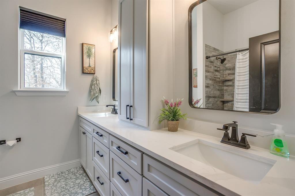 1040 Rose Court Nemo, TX 76070 - Photo 32 of 40 a bathroom with a sink and a mirror