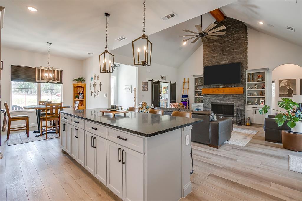 1040 Rose Court Nemo, TX 76070 - Photo 9 of 40 a kitchen with stainless steel appliances kitchen island a large island in the center