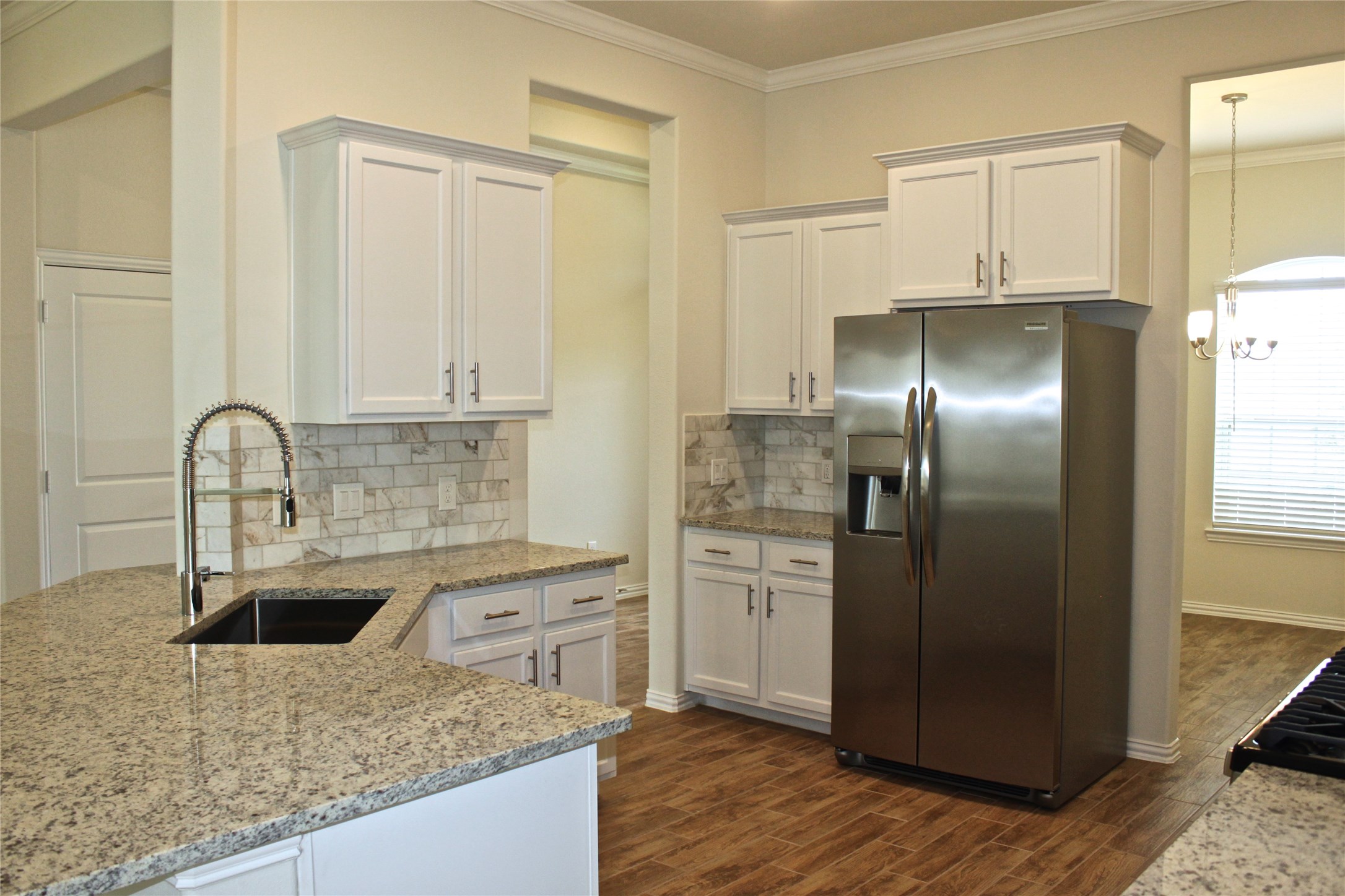 4408 Mimic Drive Spring, TX 77386 - Photo 5 of 27 a kitchen with stainless steel appliances granite countertop a refrigerator a sink and white cabinets