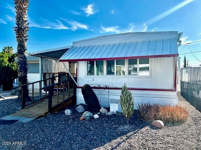 a backyard of a house with barbeque oven table and chairs