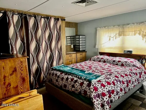 a bedroom with a bed and a window