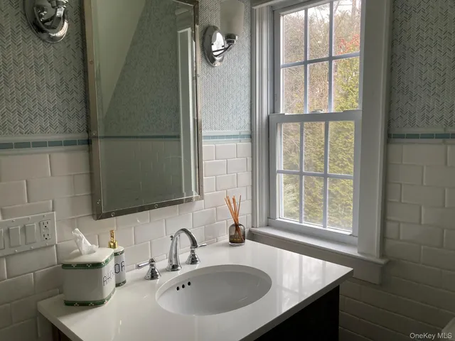 a bathroom with a sink and a window