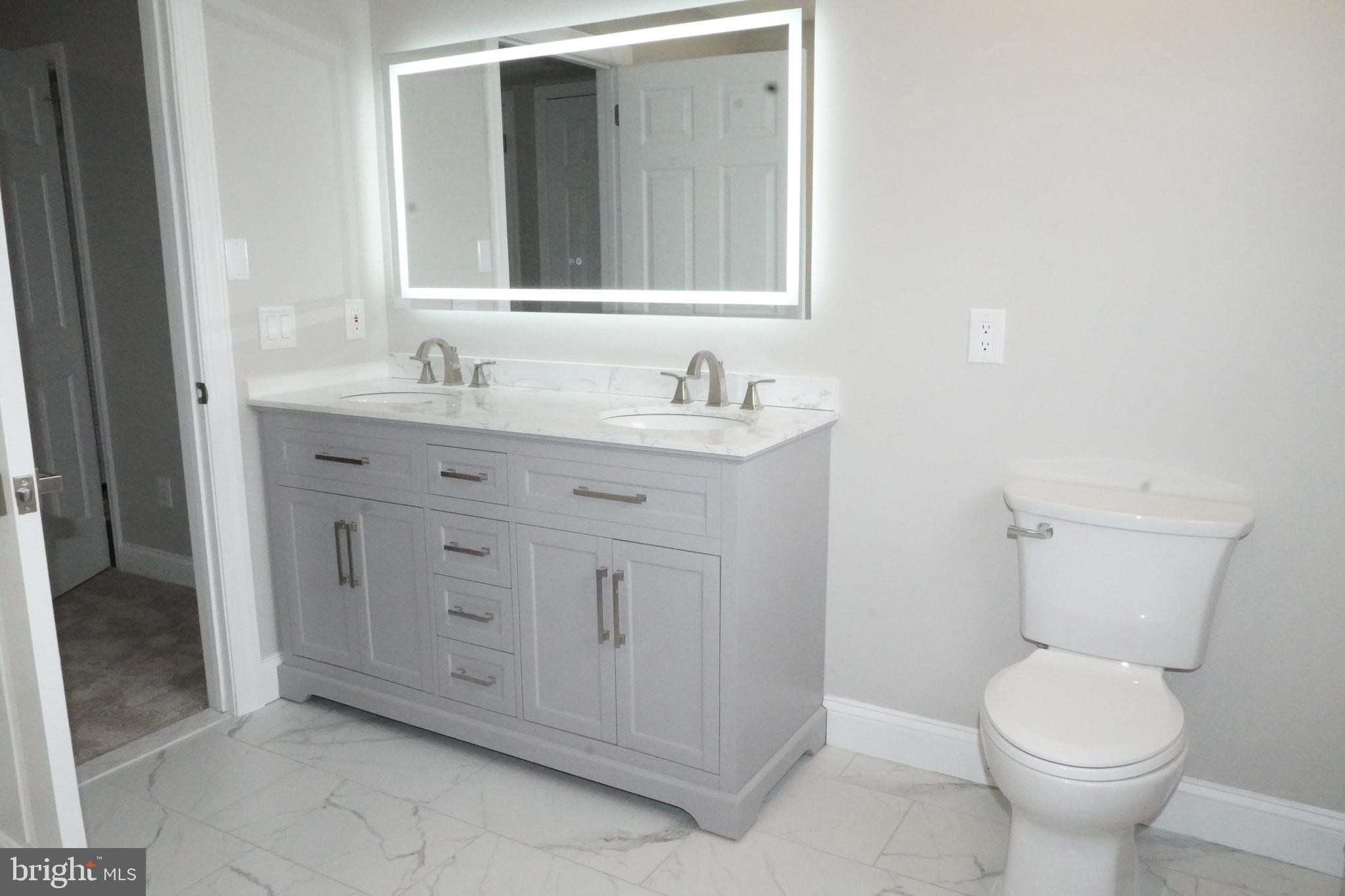 7308 B Normandy Drive Mount Laurel, NJ 08054 - Photo 11 of 23 a bathroom with a granite countertop toilet sink and mirror