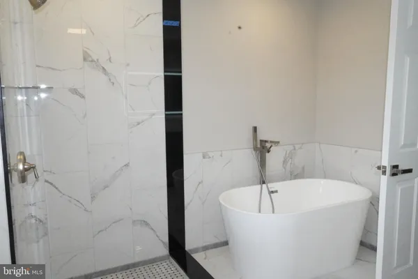 a bathroom with a bathtub and shower