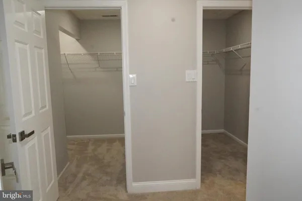 a view of an empty room with racks on the wall