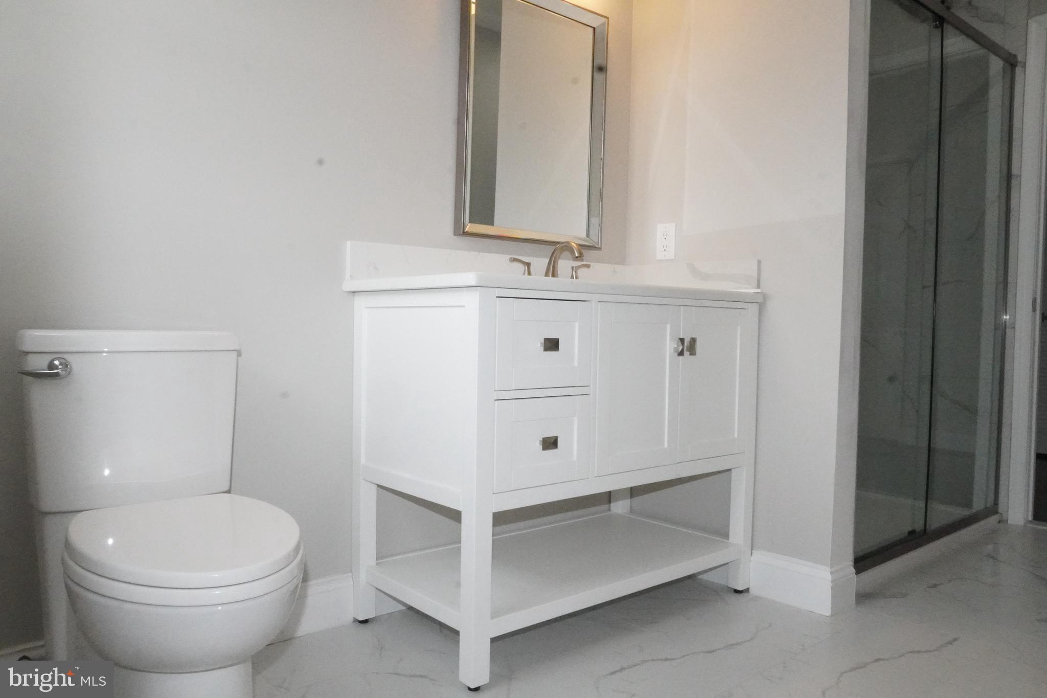 7308 B Normandy Drive Mount Laurel, NJ 08054 - Photo 17 of 23 a bathroom with a sink a toilet and mirror