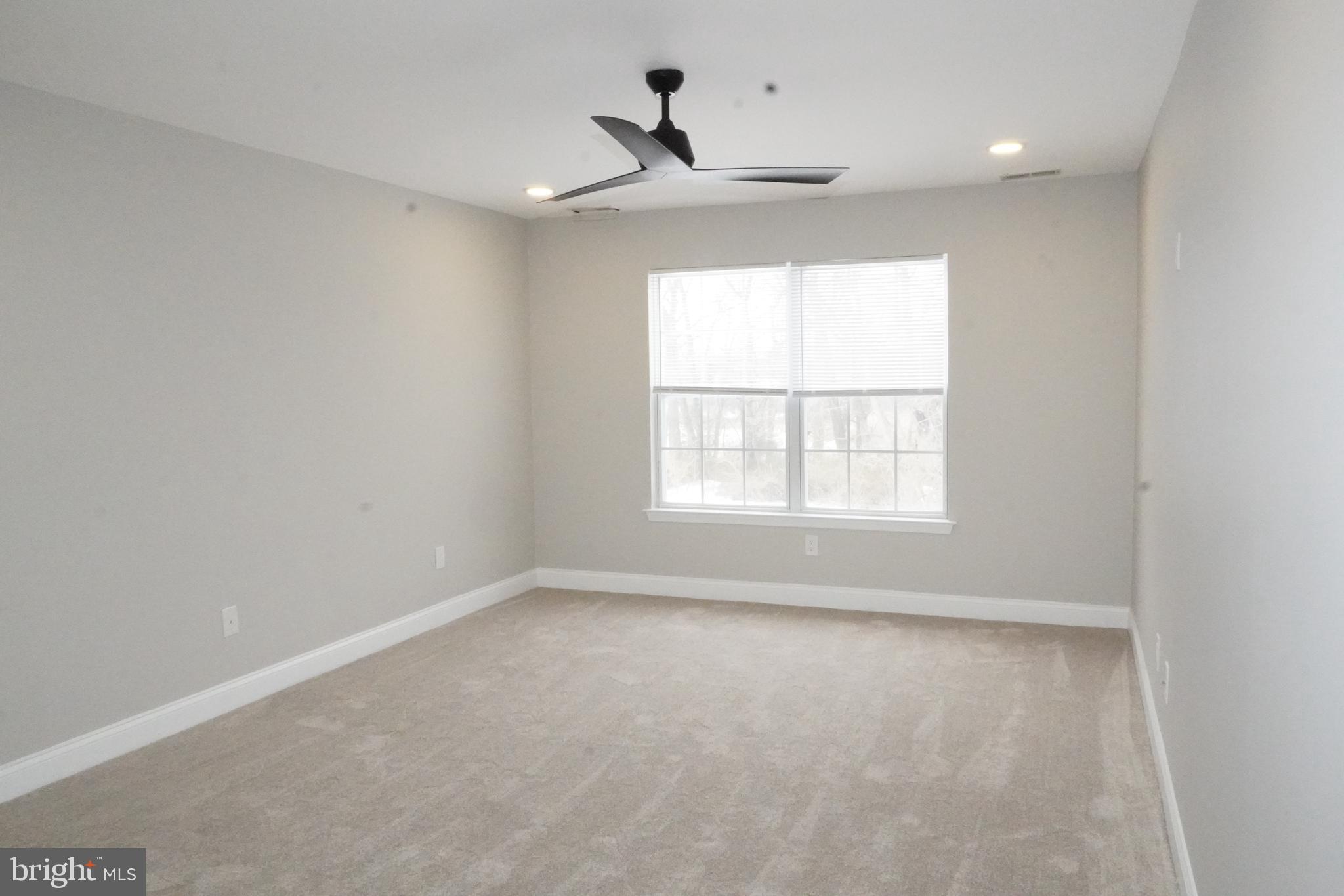 7308 B Normandy Drive Mount Laurel, NJ 08054 - Photo 10 of 23 an empty room with a window and a ceiling fan