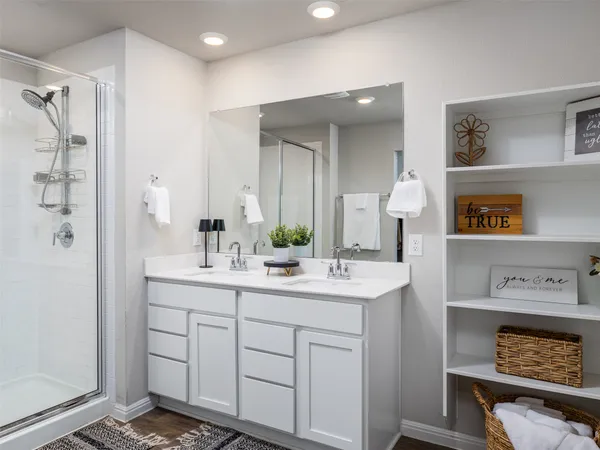 a spacious bathroom with a shower sink and mirror