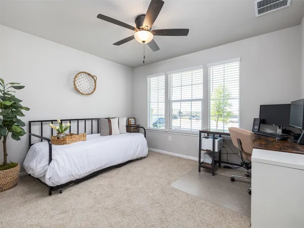 a bedroom with furniture and a window