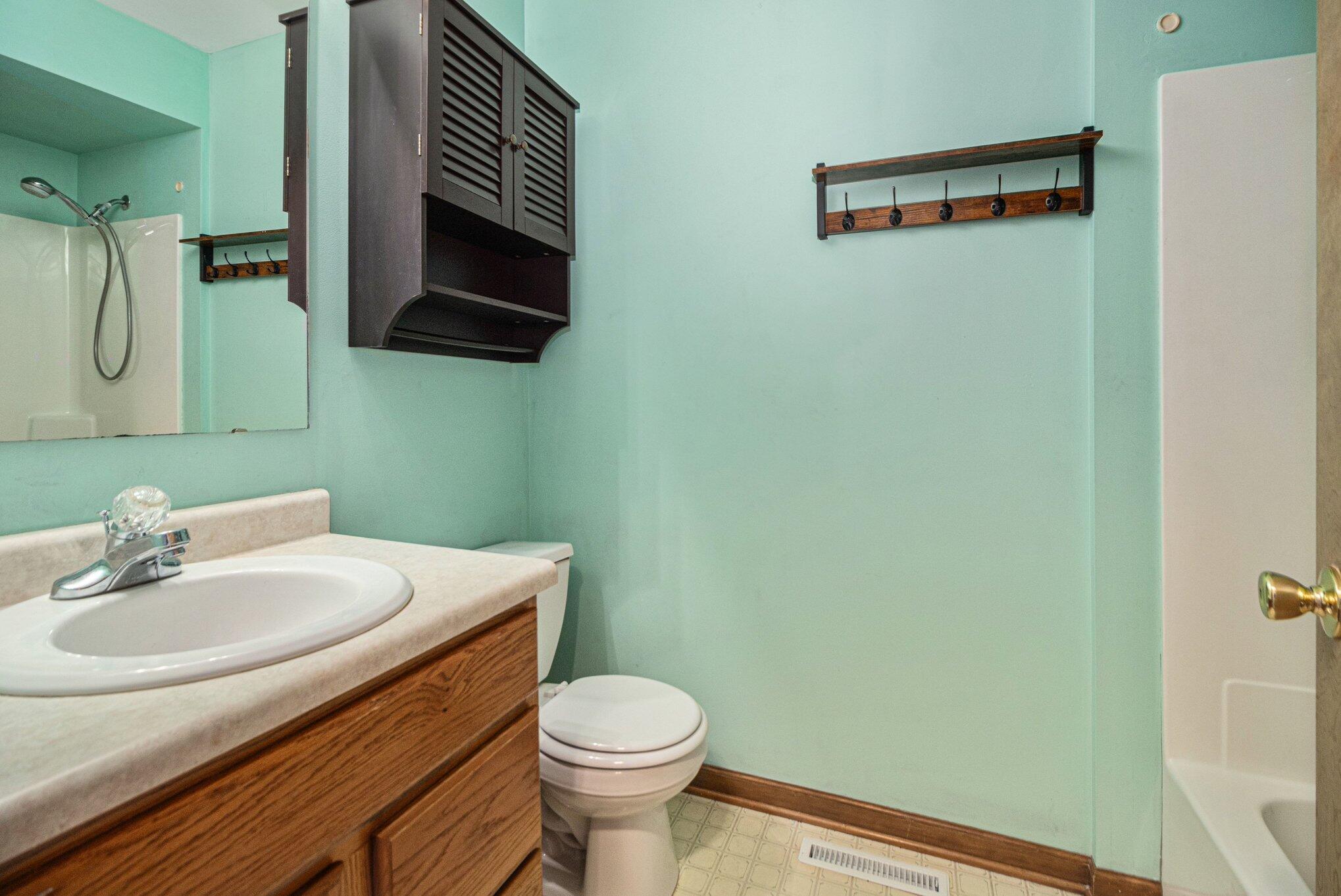 9082 Dallas Place Crown Point, IN 46307 - Photo 12 of 20 a bathroom with a sink a toilet and mirror