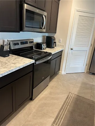 a kitchen with a sink stove and microwave