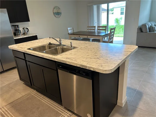 a kitchen with a sink cabinets and a wooden floor