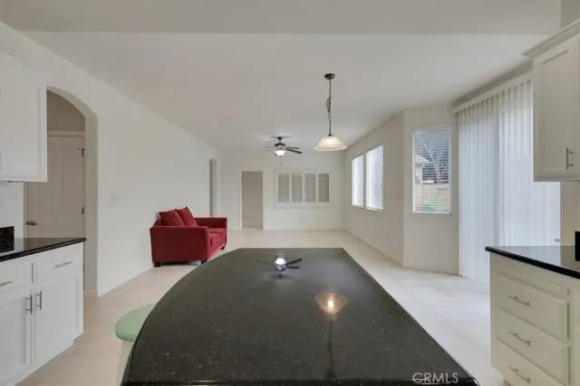 a spacious bedroom with a bed and a chandelier