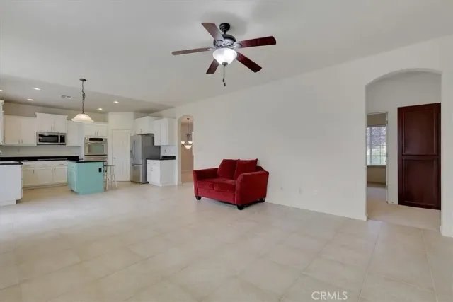 a kitchen with stainless steel appliances kitchen island granite countertop a refrigerator and a stove top oven