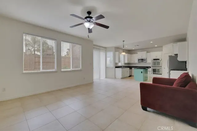 a living room with furniture and kitchen view