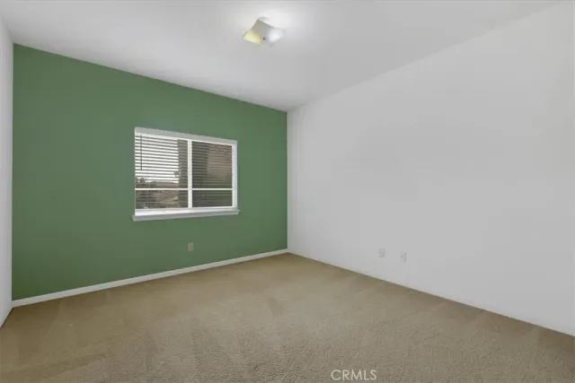 an empty room with furniture and a natural light