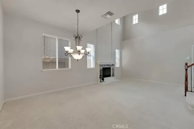 a view of a room with window and chandelier