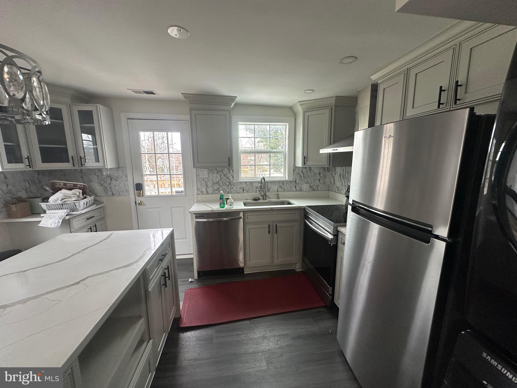 5904 K Street Capitol Heights, MD 20743 - Photo 22 of 30 a kitchen with a sink a refrigerator and window
