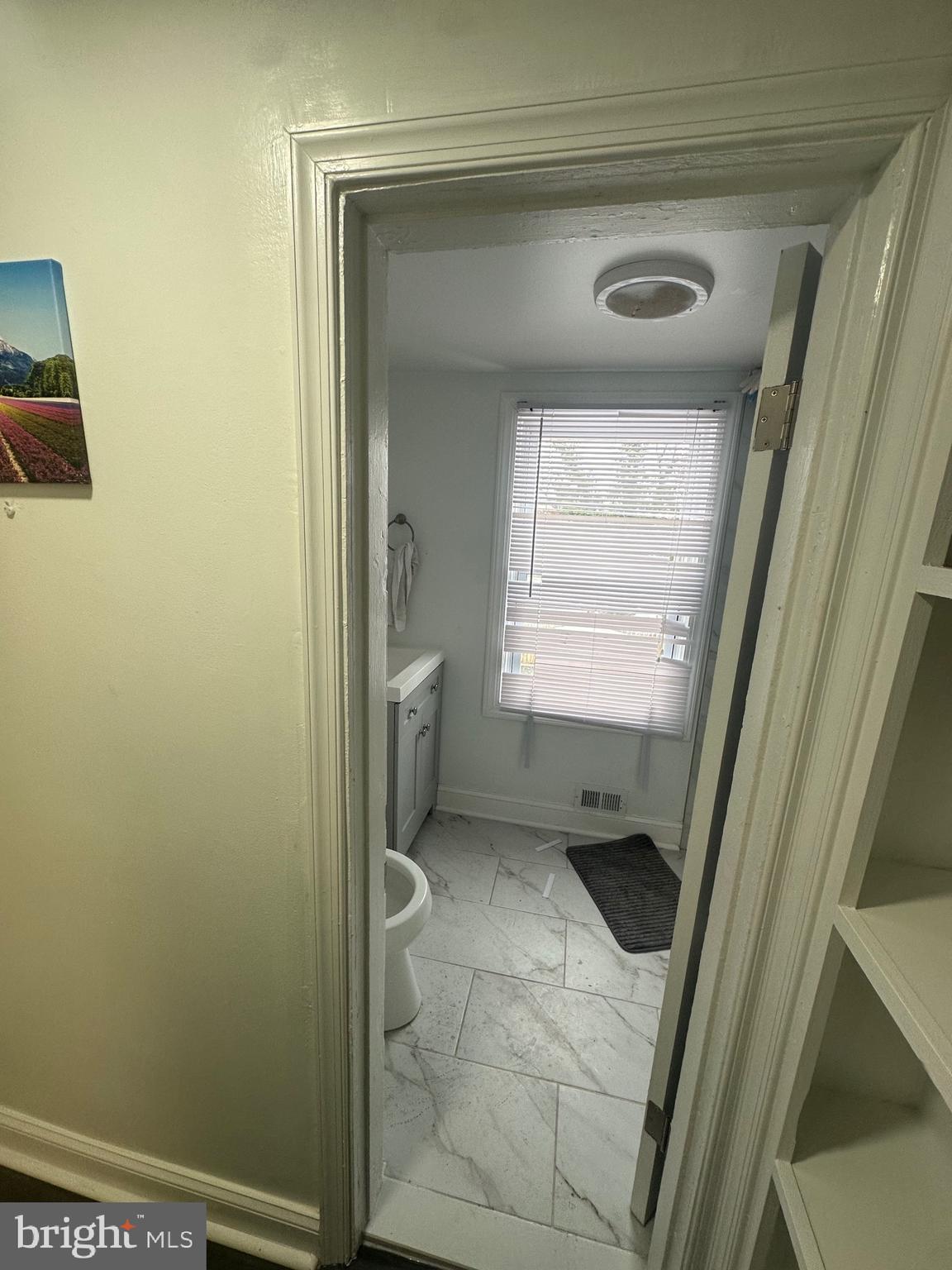 5904 K Street Capitol Heights, MD 20743 - Photo 5 of 30 a bathroom with a toilet sink and a mirror