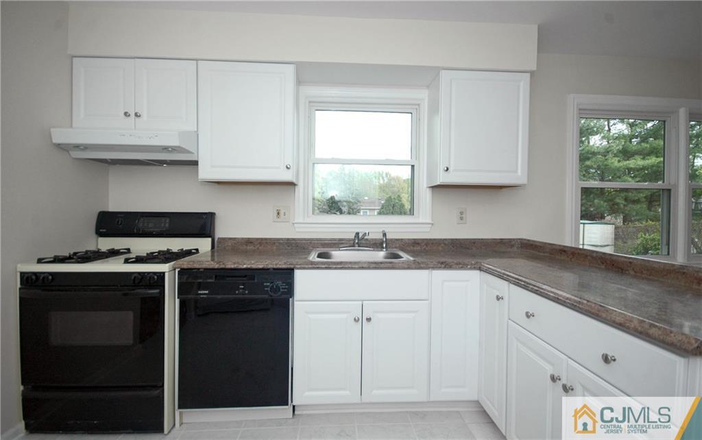 43 Brookside Road Edison, NJ 08817 - Photo 4 of 21 a kitchen with granite countertop white cabinets and a stove