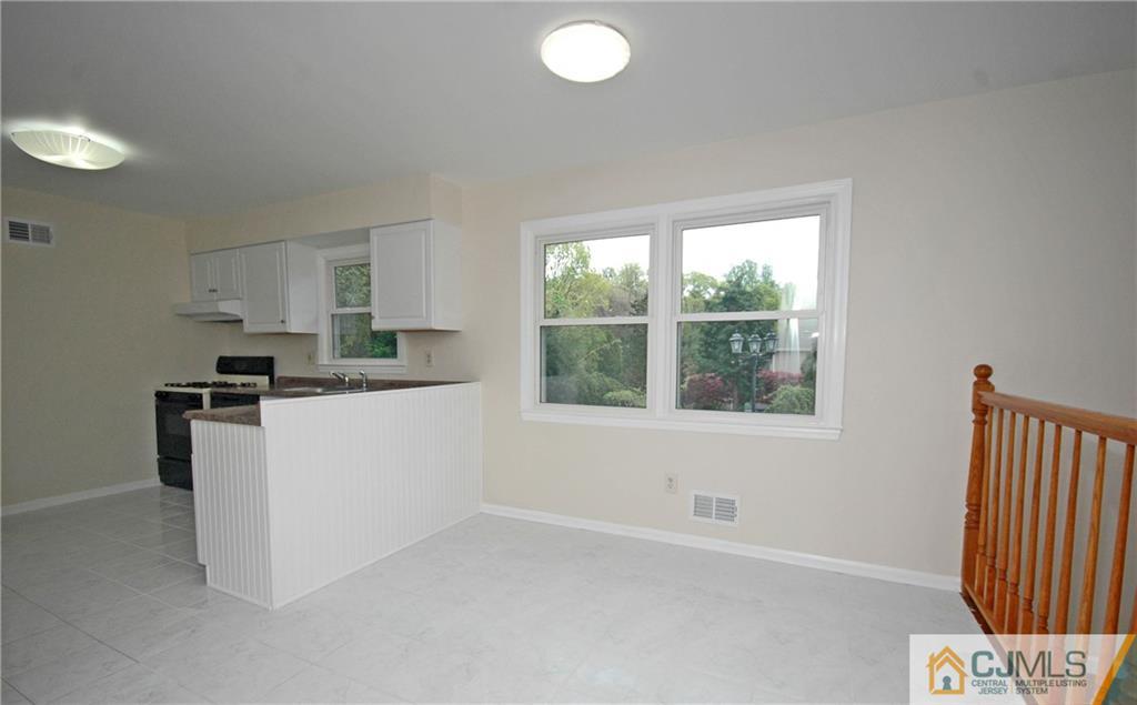 43 Brookside Road Edison, NJ 08817 - Photo 7 of 21 a kitchen with a refrigerator and window