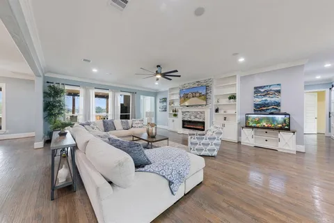 a kitchen with a dining table chairs and white cabinets