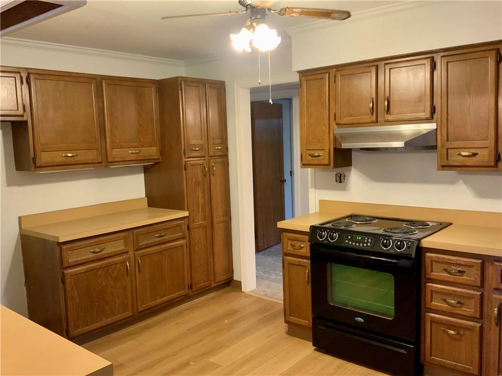 630 Broughton Road Bethel Park, PA 15102 - Photo 21 of 25 a kitchen with stainless steel appliances granite countertop a stove a refrigerator and a microwave