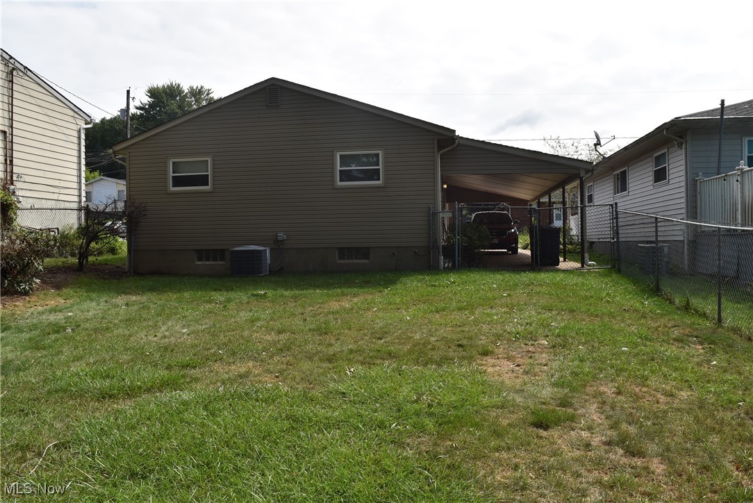 608 Gibbs Road Akron, OH 44312 - Photo 3 of 40 Rear view of property with central AC unit and a yard