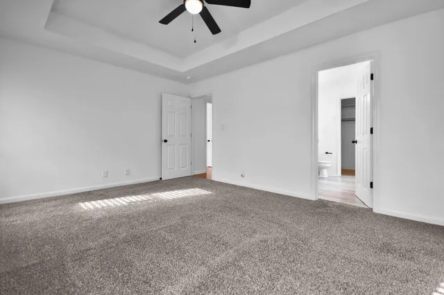 an empty room with a empty space and a ceiling fan