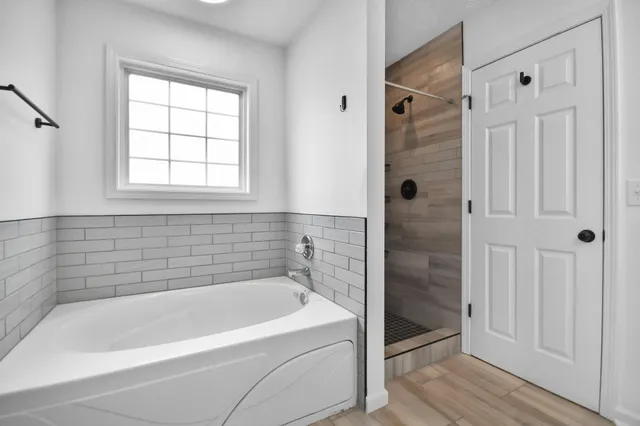 a bathroom with a bathtub and a shower